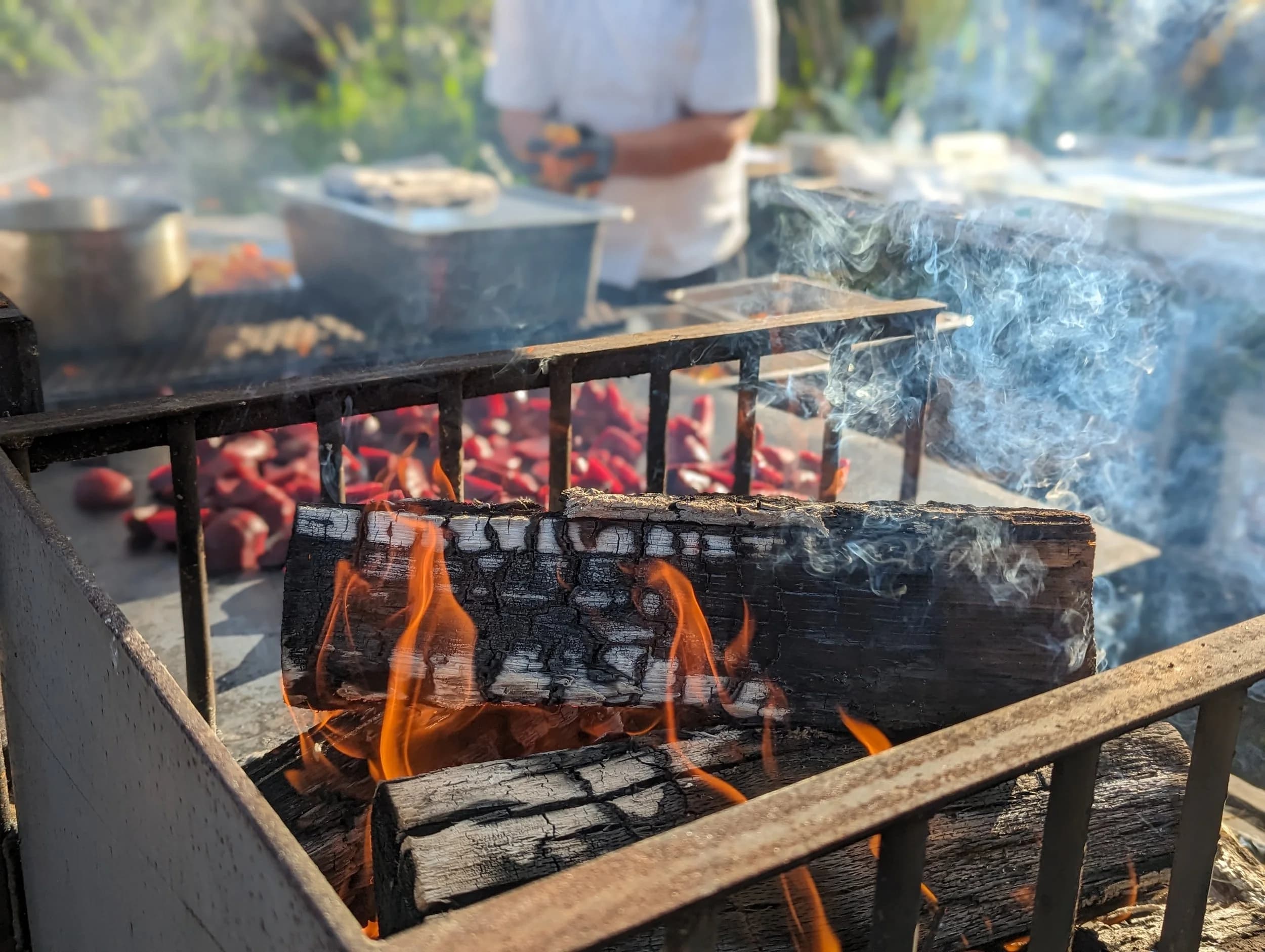 Open fire and embers with chiles roasting