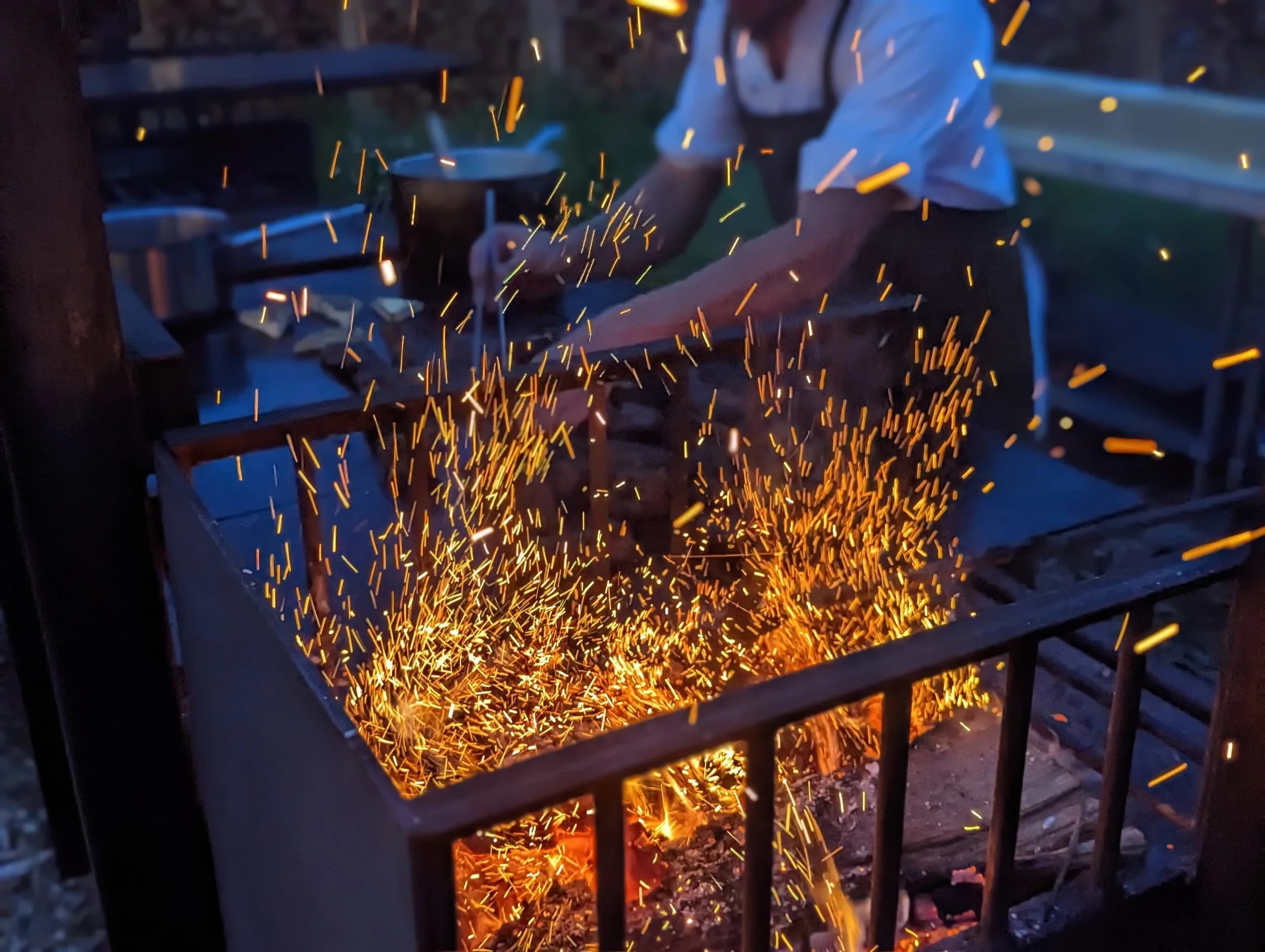 Sparks flying from the open-fire grill