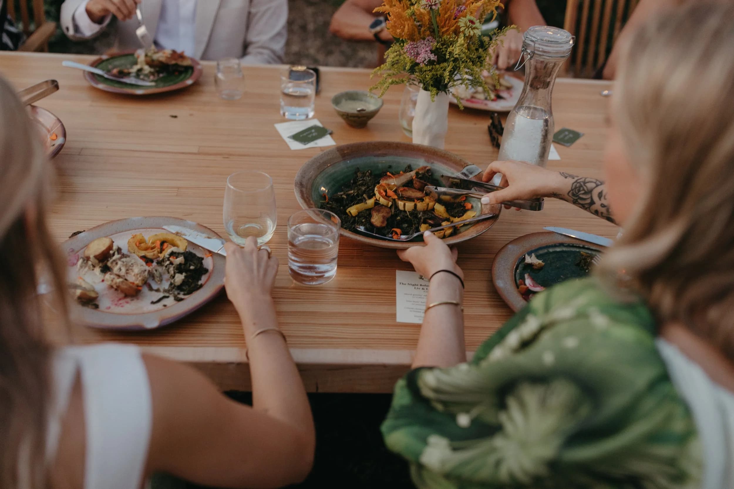 Family-style plate being passed at the long table