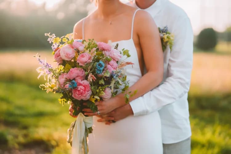 Bride holding a wildflower bouquet in close-up